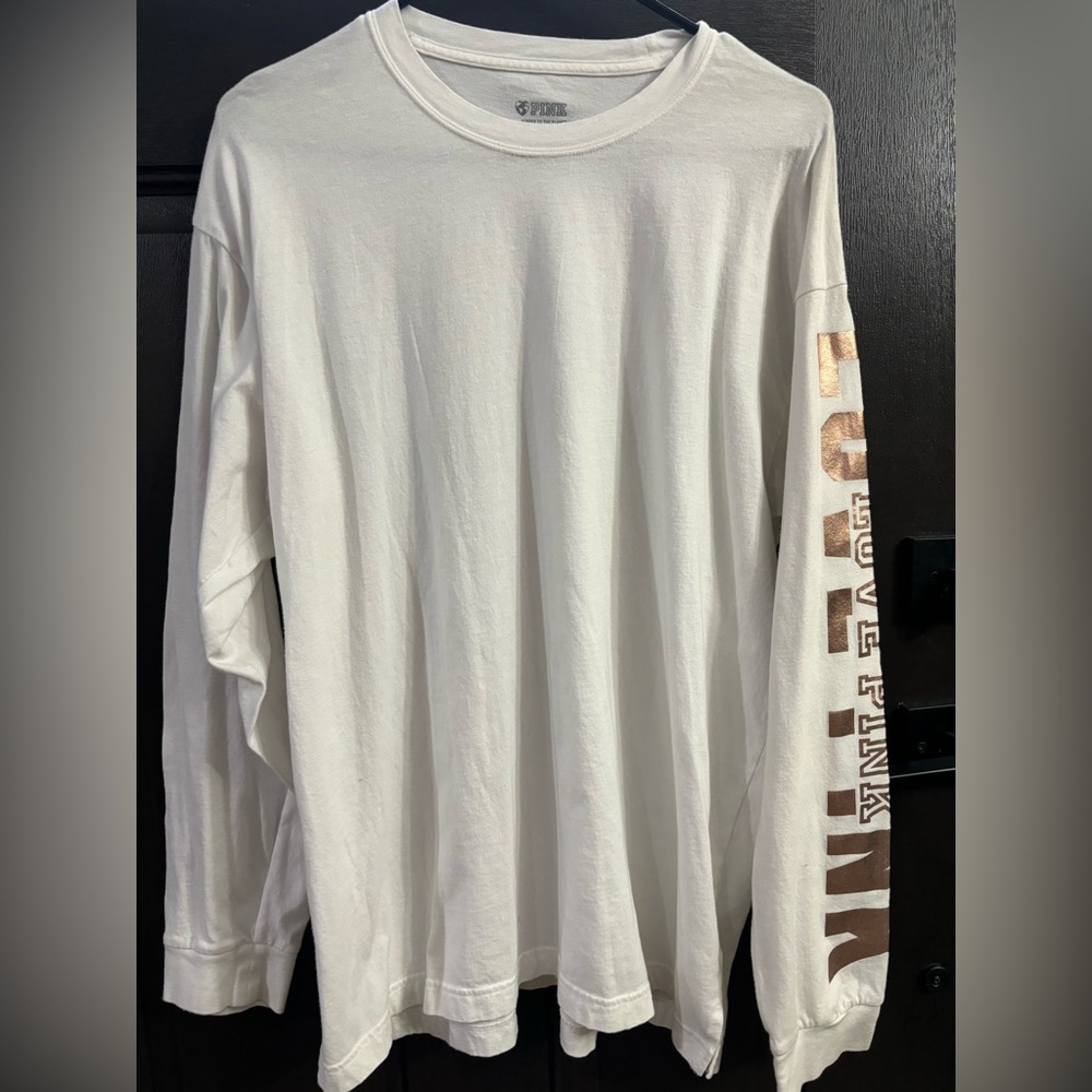 VS PINK long sleeve white shirt with rose gold lettering down the left arm.